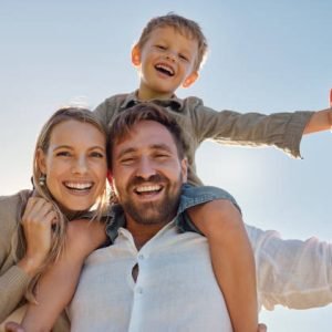 Family, mother and father with child, for holiday, vacation and being happy together outdoor. Portrait, mama and dad with kid for quality time, travel and bonding being loving, carry boy and have fun